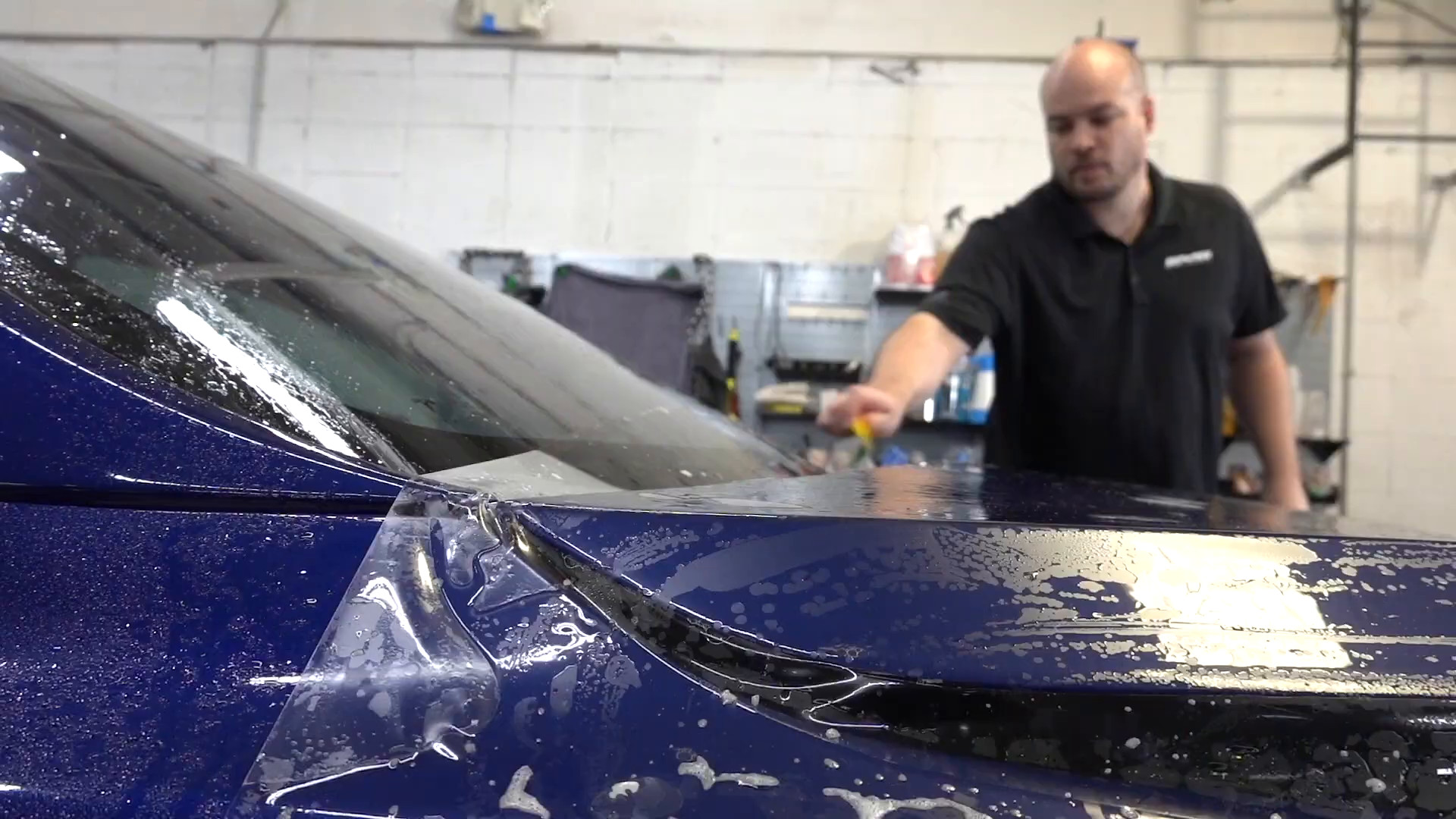 Paint protection film being installed on a Tesla Model S Plaid hood at EVS Motors