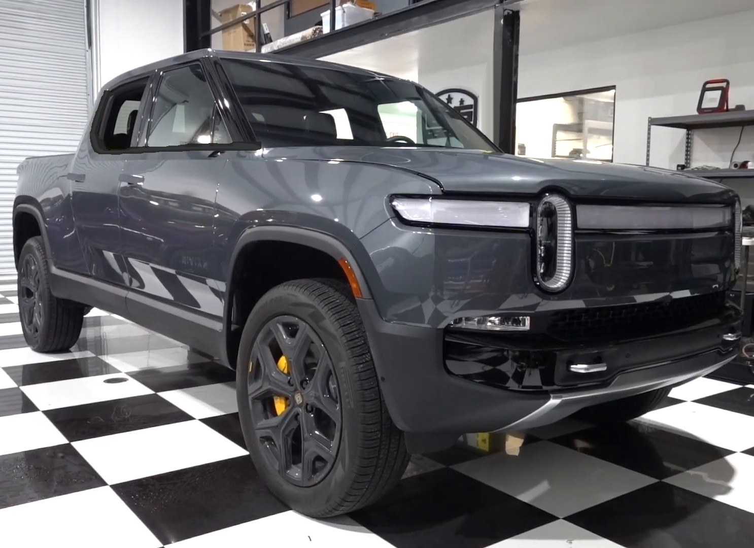 Gray Rivian R1T electric pickup inside the EVS Motors shop in Houston