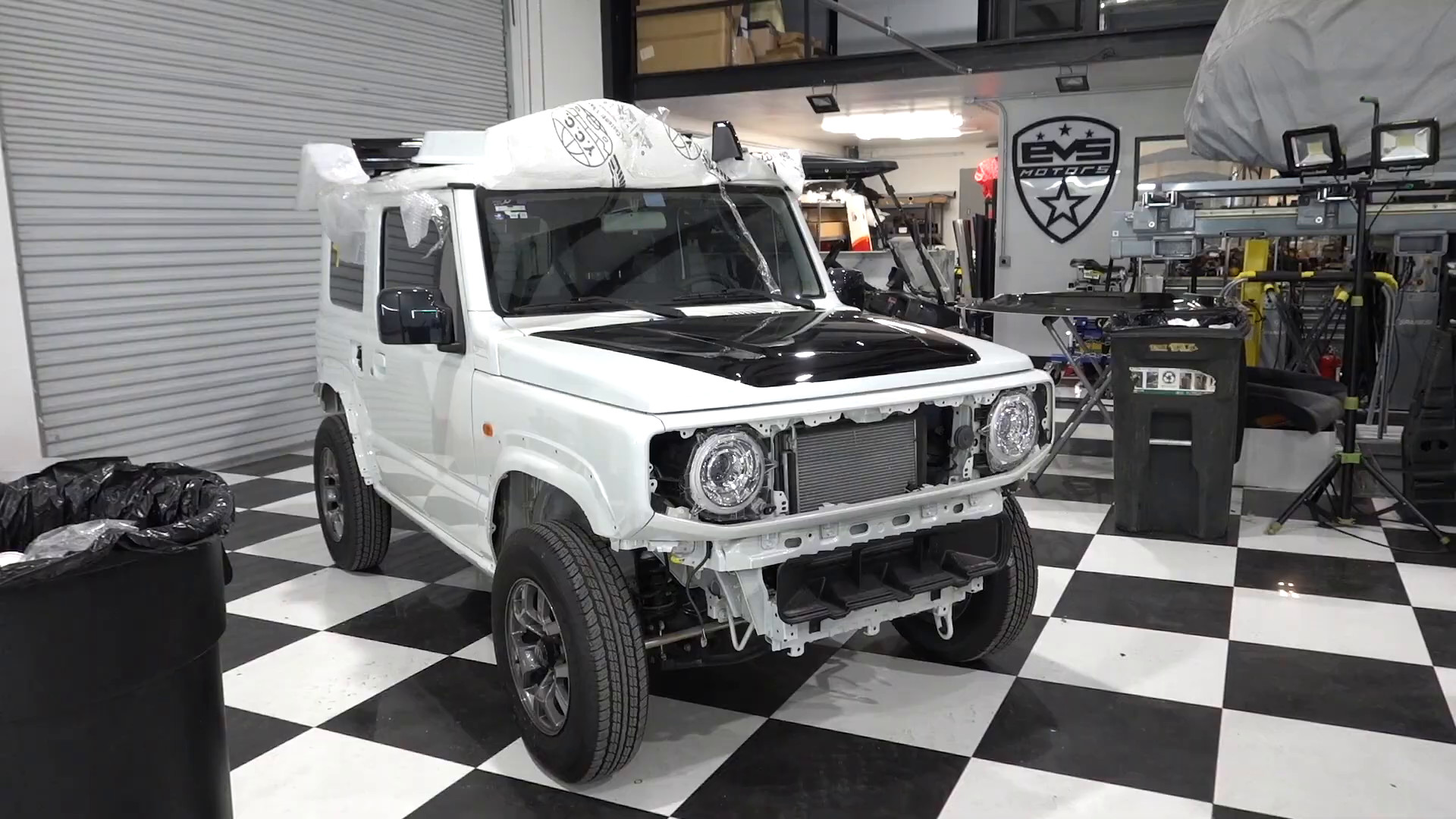 A custom SUV build on the checkered floor inside the EVS Motors shop